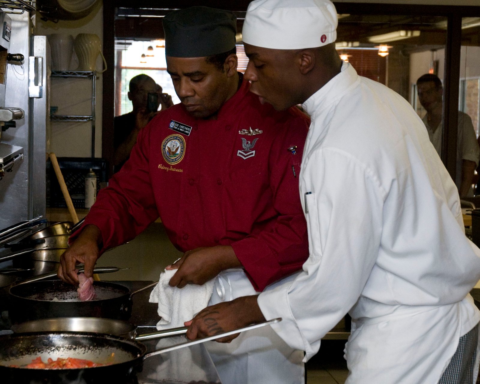 Chef instructor working with a culinary student